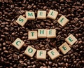 Can you smell that perfect brew. Closeup shot of block letters forming the words smell the coffee on a pile of coffee