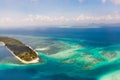 Canabungan Island with sandy beach. Tropical island with white beach on the large atoll, aerial view