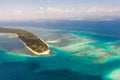 Canabungan Island with sandy beach. Tropical island with white beach on the large atoll, aerial view