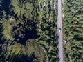 Beautiful Canada camper bus driving on road endless pine tree forest with lakes moor land aerial view travel background