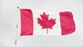 canada canadian flag blowing waving in wind on flagpole with sky behind, close 1 v