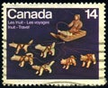 CANADA - CIRCA 1978: stamp 14 Canadian cents printed by Canada, shows Dogteam and Dogsled ivory sculpture by Abraham Kingmeatook Royalty Free Stock Photo