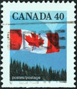 CANADA - CIRCA 1989: A stamp printed in Canada shows flag over forest, circa 1989.