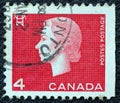 CANADA - CIRCA 1962: A stamp printed in Canada shows a portrait of Queen Elizabeth II and Electricity pylon symbol, circa 1962.