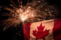 Canada Day Fireworks explode behind a canadian flag. AI generation Royalty Free Stock Photo