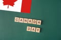 Canada dey lined with letters next to flag on green background Royalty Free Stock Photo