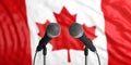 Canada flag background with two microphones in front of it. Close up view. 3d illustration