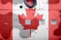 Canada flag depicted on side part of military armored helicopter closeup. Army forces aircraft conceptual background Royalty Free Stock Photo