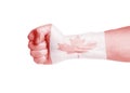 Canada flag painted on male hand with clenched a fist