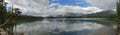 Peaceful and serene Lac Beauvert, with majestic Mount Merlin in the background