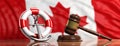 Lifebuoy, ship anchor and justice gavel on Canadian flag background, banner. 3d illustration Royalty Free Stock Photo