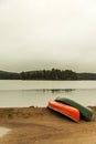 Canada Ontario Lake two rivers grey morning dark atmosphere Canoe Canoes parked beach water in Algonquin National Park