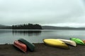 Canada Ontario Lake two rivers grey morning dark atmosphere Canoe Canoes parked beach water in Algonquin National Park