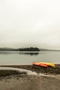 Canada Ontario Lake two rivers grey morning dark atmosphere Canoe Canoes parked beach water in Algonquin National Park