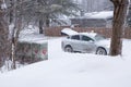 Canada Post car stopped with trunk open at community mailbox during a snowstorm Royalty Free Stock Photo