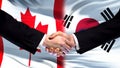 Canada and South Korea handshake, international friendship, flag background