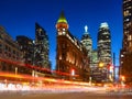 Canada, Toronto. The famous Gooderham building and the skyscrapers in the background. View of the city in the evening. Blurring tr Royalty Free Stock Photo