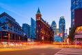 Canada, Toronto. The famous Gooderham building and the skyscrapers in the background. View of the city in the evening. Blurring tr Royalty Free Stock Photo