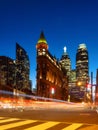 Canada, Toronto. The famous Gooderham building and the skyscrapers in the background. View of the city in the evening. Blurring tr