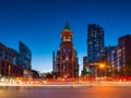 Canada, Toronto. The famous Gooderham building and the skyscrapers in the background. View of the city in the evening. Blurring tr