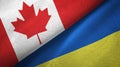 Canada and Ukraine two flags textile cloth, fabric texture