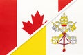 Canada and Vatican City, symbol of national flags from textile. Championship between two countries Royalty Free Stock Photo