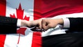 Canada vs Syria conflict, international relations, fists on flag background Royalty Free Stock Photo