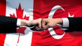 Canada vs Turkey conflict, international relations, fists on flag background Royalty Free Stock Photo