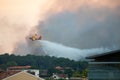 A Canadair dropping water on forest fire in Anglet, France.