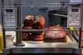 Canadian bacon, also known as peameal, for sale, grilled and cooked, on a shop in St Lawrence Market, downtown Toronto