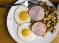 canadian bacon with fried eggs and home fries