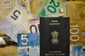 Canadian currency of denomination 5, 10, 20, 100 with Indian Passport