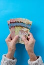 Canadian currency. Dollars. Above view of old retired person paying in cash Royalty Free Stock Photo