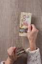 Canadian currency. Dollars. Above view of old retired person pay Royalty Free Stock Photo