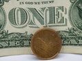 Canadian dollar coin next to a dollar bill. Royalty Free Stock Photo