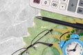20 Canadian dollars bills and calculator with glasses and pen. Business loan or tax payment season concept. Time to pay taxes Royalty Free Stock Photo