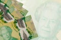 20 Canadian dollars bills lies in stack on background of big semi-transparent banknote. Abstract business background