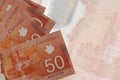 50 Canadian dollars bills lies in stack on background of big semi-transparent banknote. Abstract business background Royalty Free Stock Photo