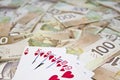 Canadian dollars and royal flush hand Royalty Free Stock Photo