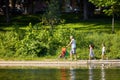 Canadian family walking near the pond in La Fontaine Park, Montreal, Canada Royalty Free Stock Photo