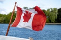 Canadian flag flies on boat`s stern