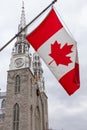 Canadian flag in front of the Notre-Dame Cathedral Basilica in Ottawa, Canada Royalty Free Stock Photo