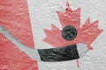 Canadian flag and hockey puck with a stick