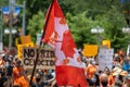 Canadian flag with indigenous children`s hand prints at protest