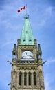 Canadian flag on a tower of the Canadian Parliament building against a blue sky. Parliament Hill, Ottawa, Ontario Royalty Free Stock Photo