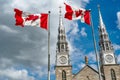 Canadian flags in the forefront of the Notre-Dame Cathedral Basilica in Ottawa. Canada Royalty Free Stock Photo