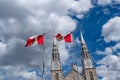 Canadian flags in the forefront of the Notre-Dame Cathedral Basilica in Ottawa. Canada Royalty Free Stock Photo