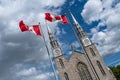 Canadian flags in the forefront of the Notre-Dame Cathedral Basilica in Ottawa. Canada Royalty Free Stock Photo