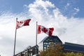 Canadian flags in the wind in front of blue sky Royalty Free Stock Photo