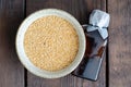Canadian flax seeds in bowl and bottle of linseed oil on wooden background. Top view Royalty Free Stock Photo